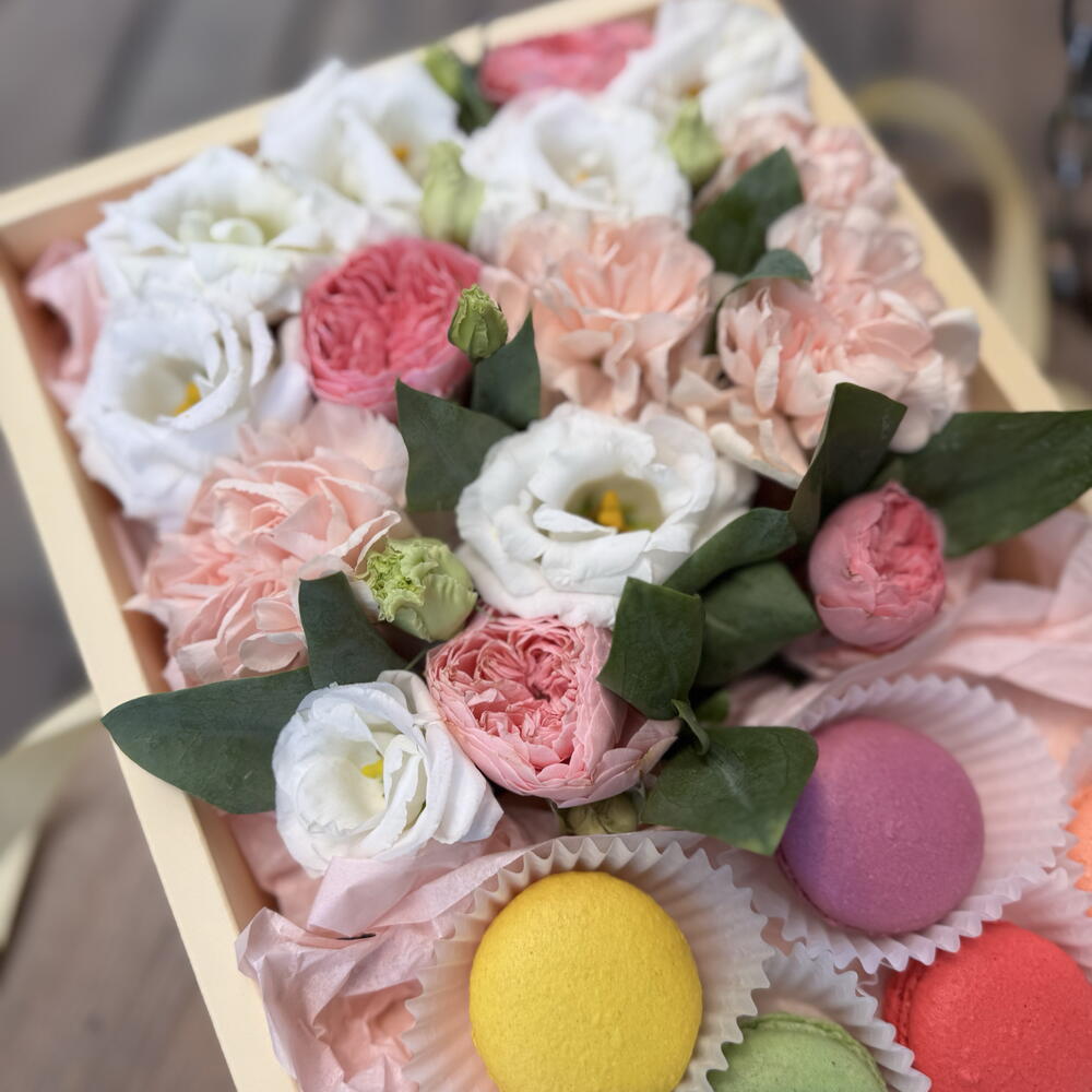 Flowers with macarons in a large box