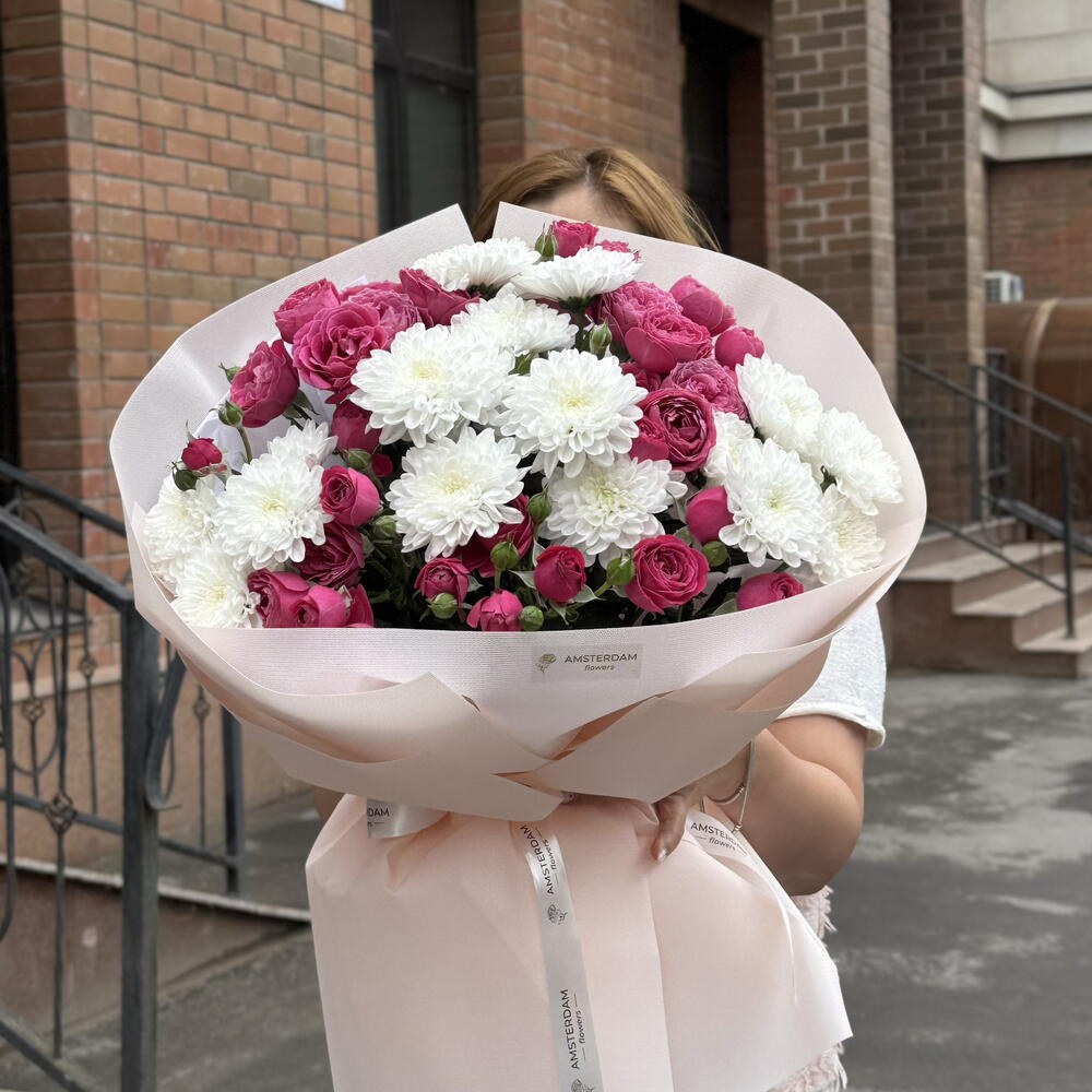 A bright bouquet featuring spray roses and a chrysanthemum.