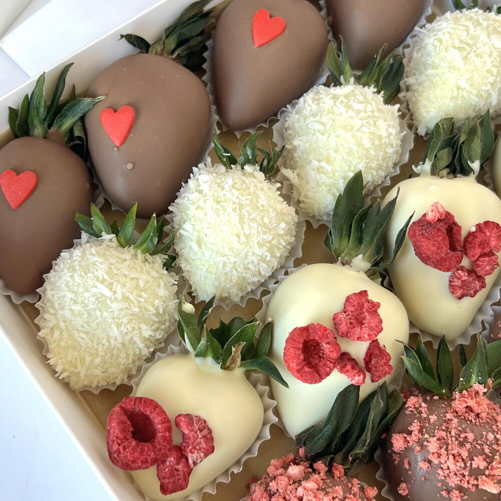 Strawberries in white and milk chocolate with freeze-dried raspberries and strawberries