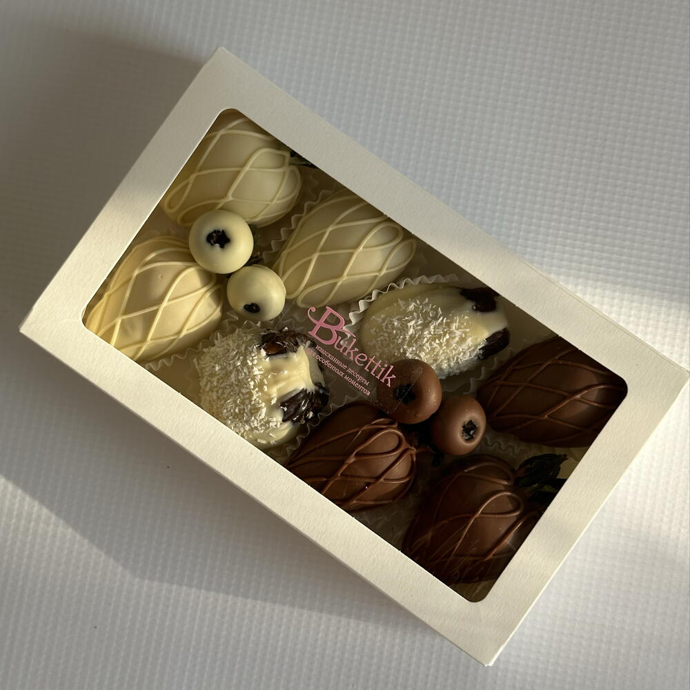 Set of strawberries, dates with fillings and blueberries in chocolate "Yin-Yang"