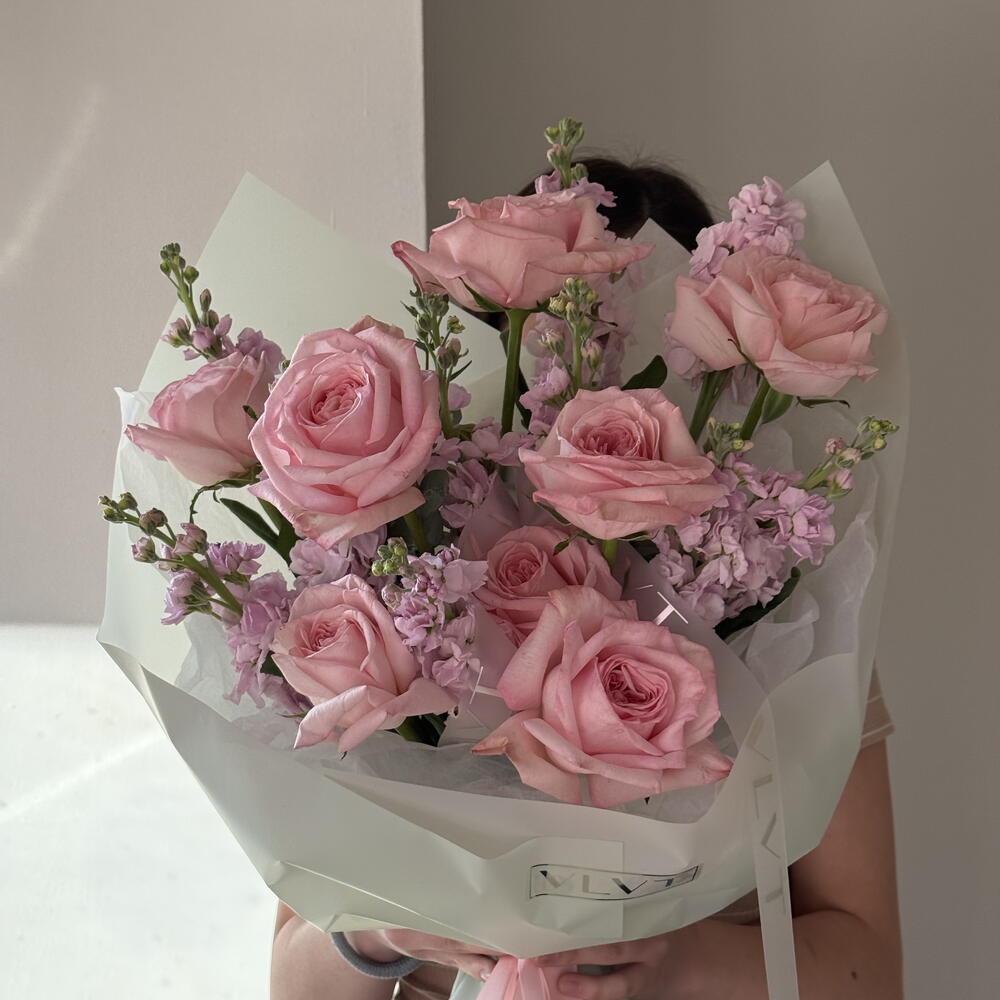 A delicate, fragrant bouquet of roses and stock.