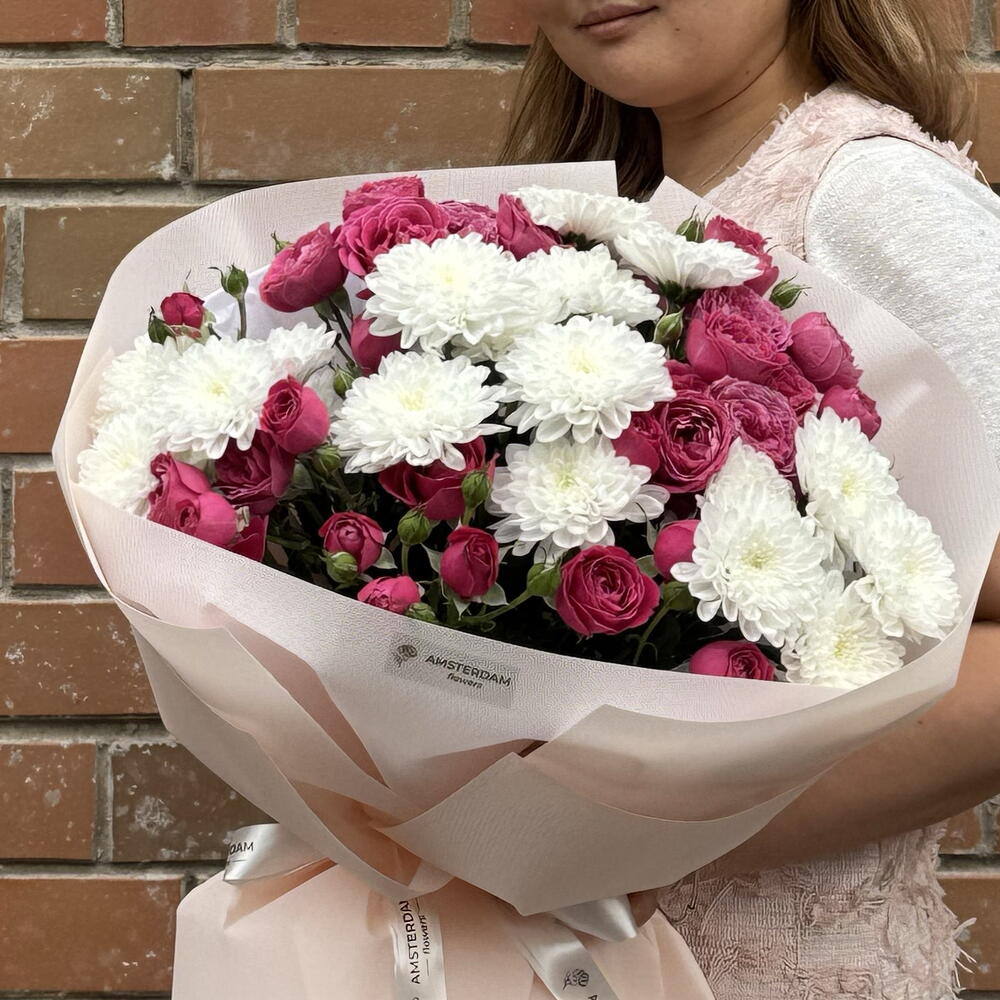 A bright bouquet featuring spray roses and a chrysanthemum.
