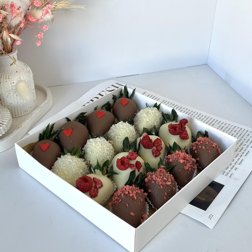 Strawberries in white and milk chocolate with freeze-dried raspberries and strawberries