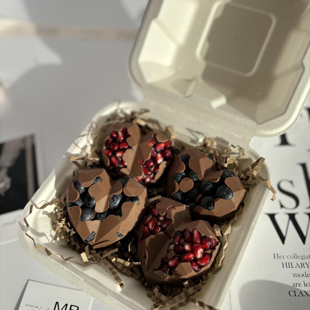 Chocolate hearts with fresh blueberries and pomegranate seeds