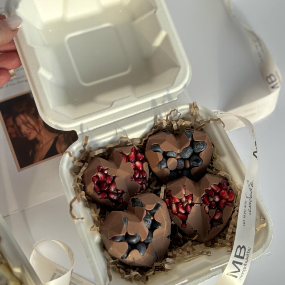 Chocolate hearts with fresh blueberries and pomegranate seeds