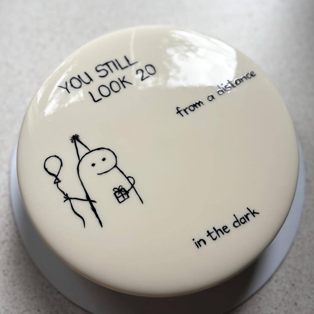 Minimalist cake with a funny inscription and simple decoration