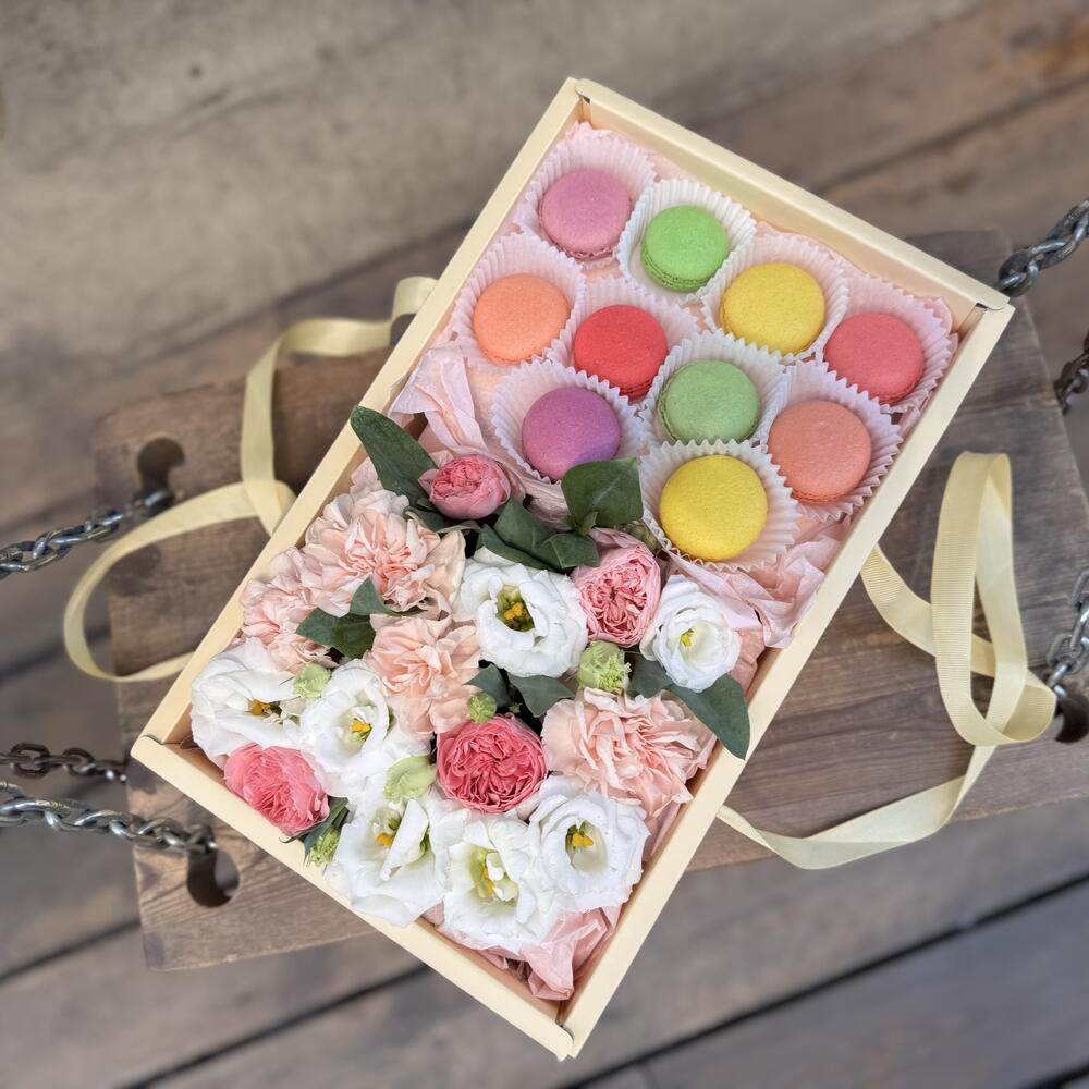 Flowers with macarons in a large box