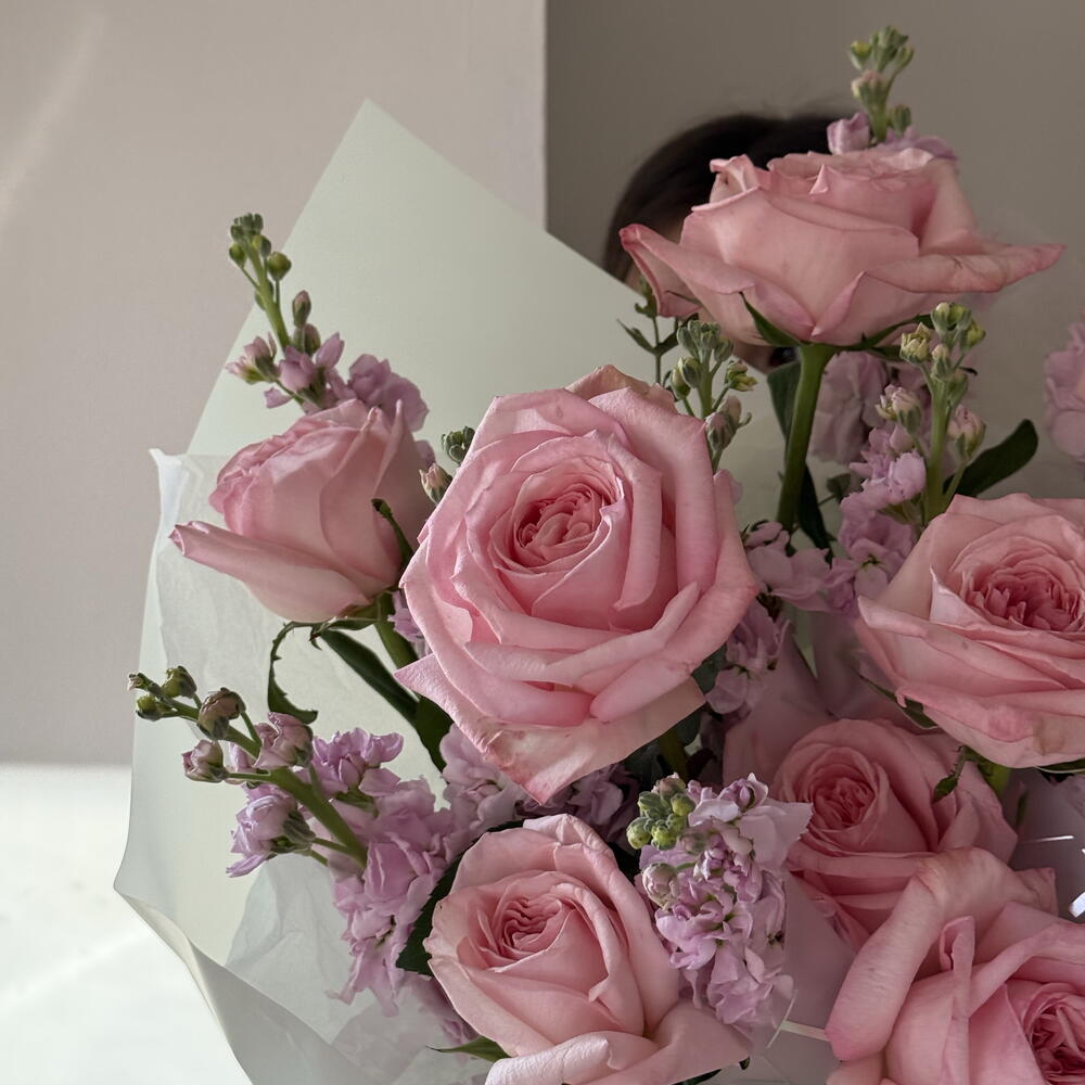 A delicate, fragrant bouquet of roses and stock.