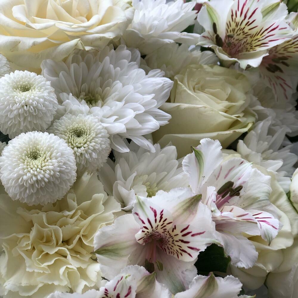 White bouquet of chrysanthemums, single-headed roses, alstroemeria and dianthus