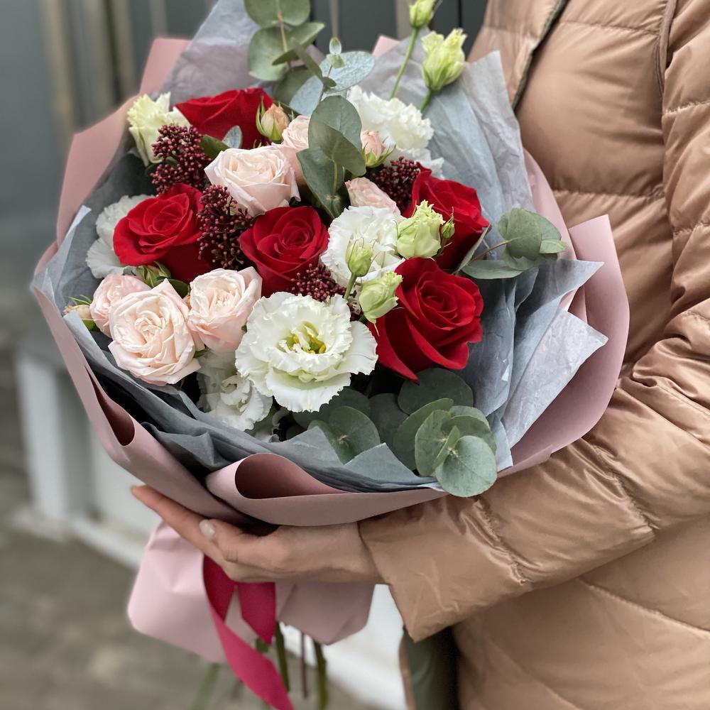 Bouquet of single-headed and bush roses, eustoma, skimmia and eucalyptus Flower ball