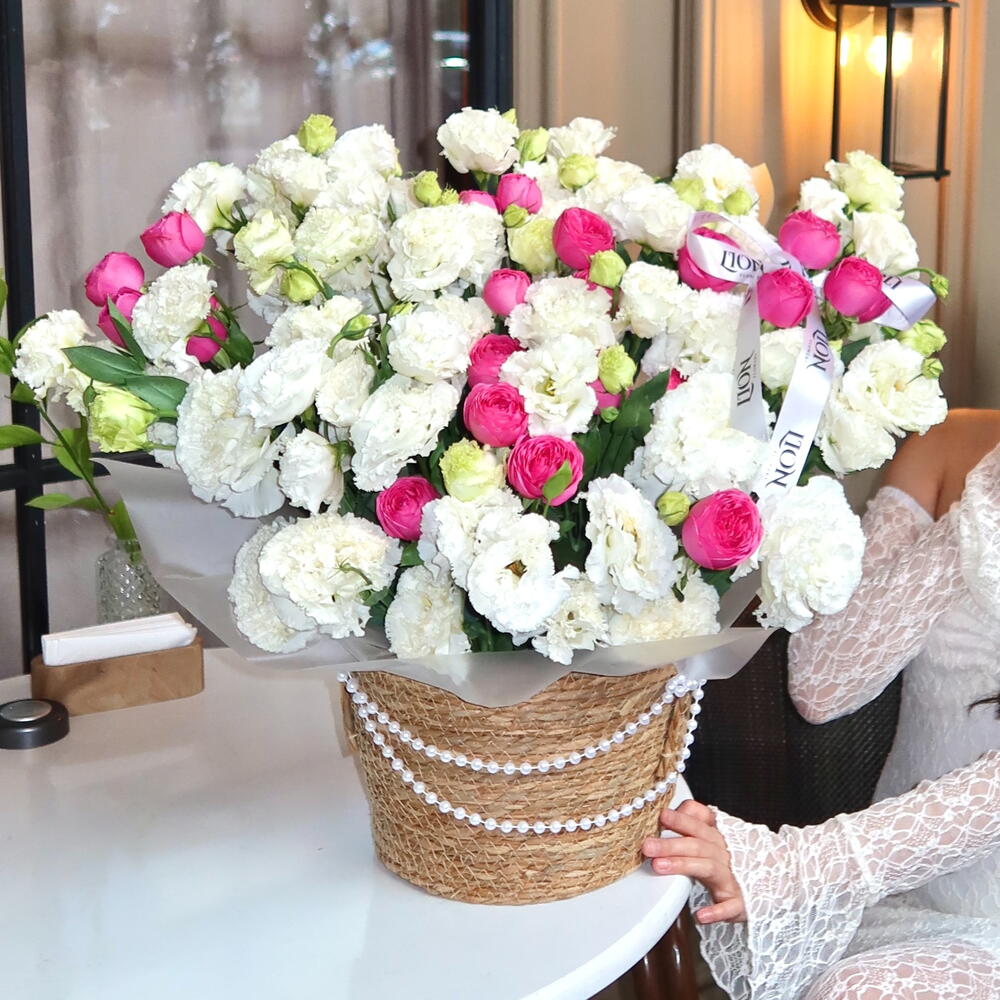 Lisianthus and peony-flowered shrub roses in a planter