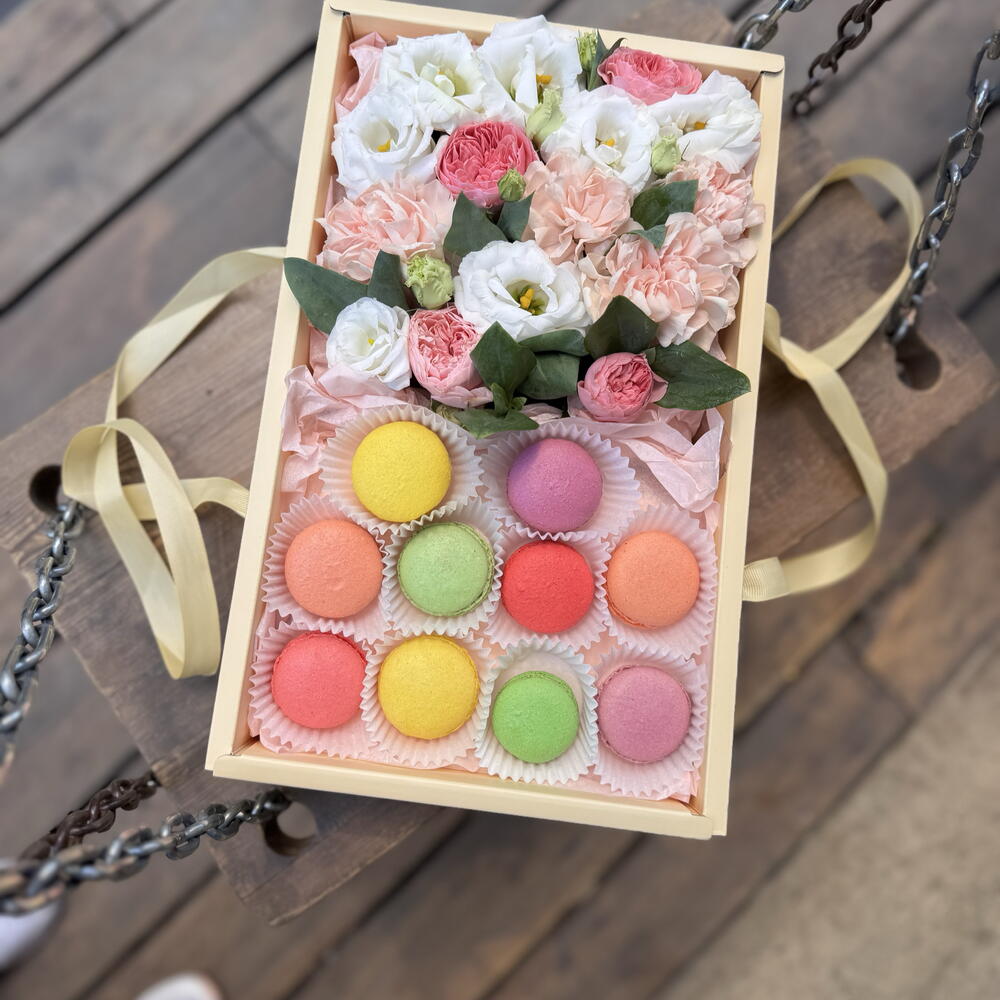 Flowers with macarons in a large box