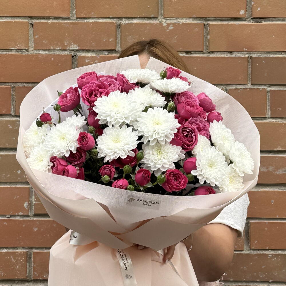 A bright bouquet featuring spray roses and a chrysanthemum.