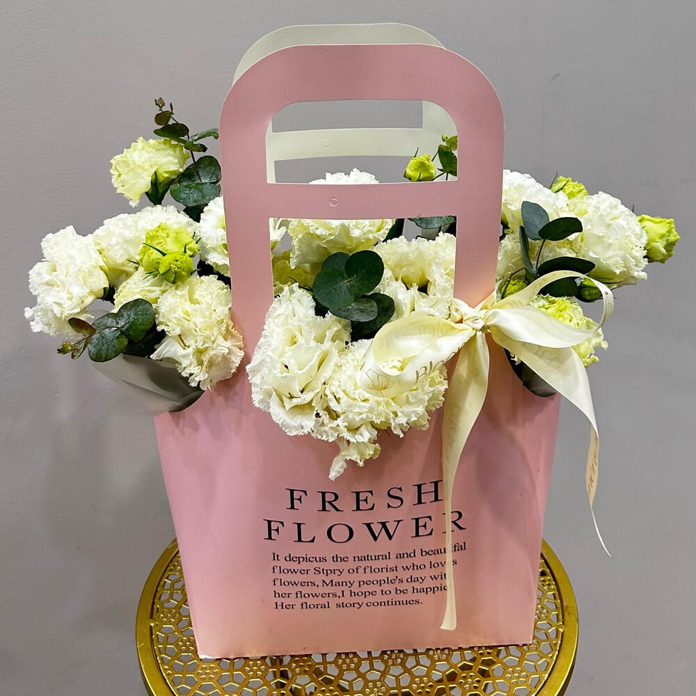 Flowers in a cardboard bag with lisianthus and eucalyptus