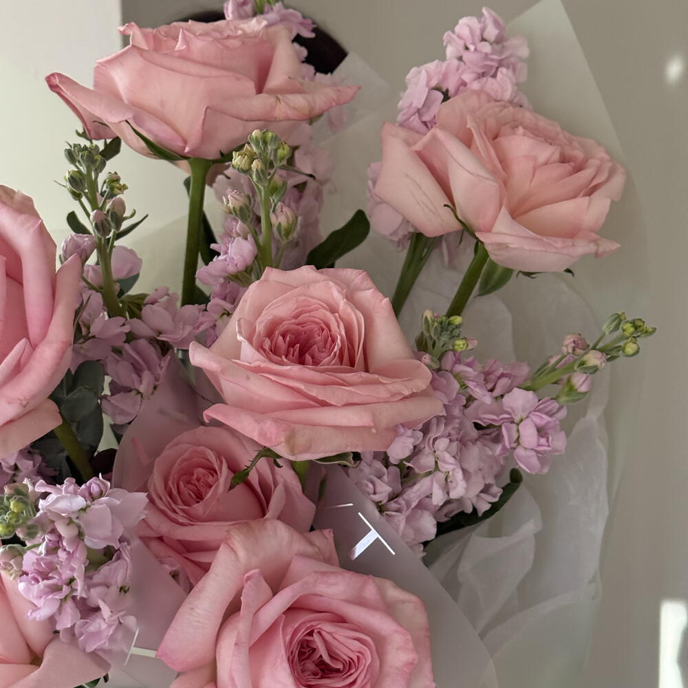 A delicate, fragrant bouquet of roses and stock.
