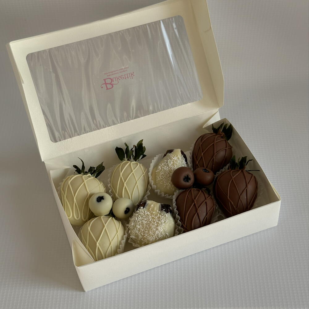 Set of strawberries, dates with fillings and blueberries in chocolate "Yin-Yang"