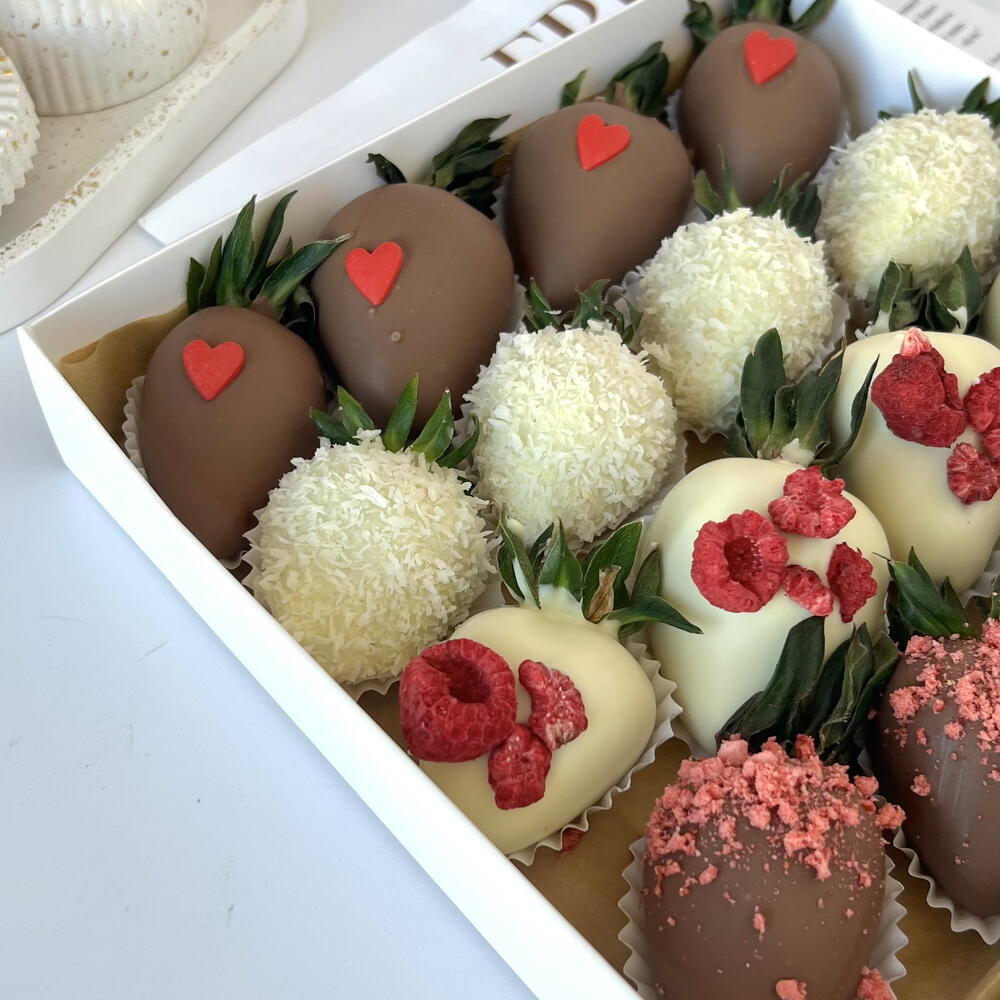 Strawberries in white and milk chocolate with freeze-dried raspberries and strawberries