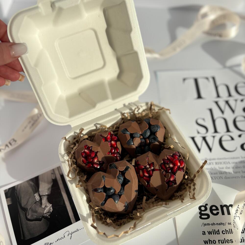 Chocolate hearts with fresh blueberries and pomegranate seeds
