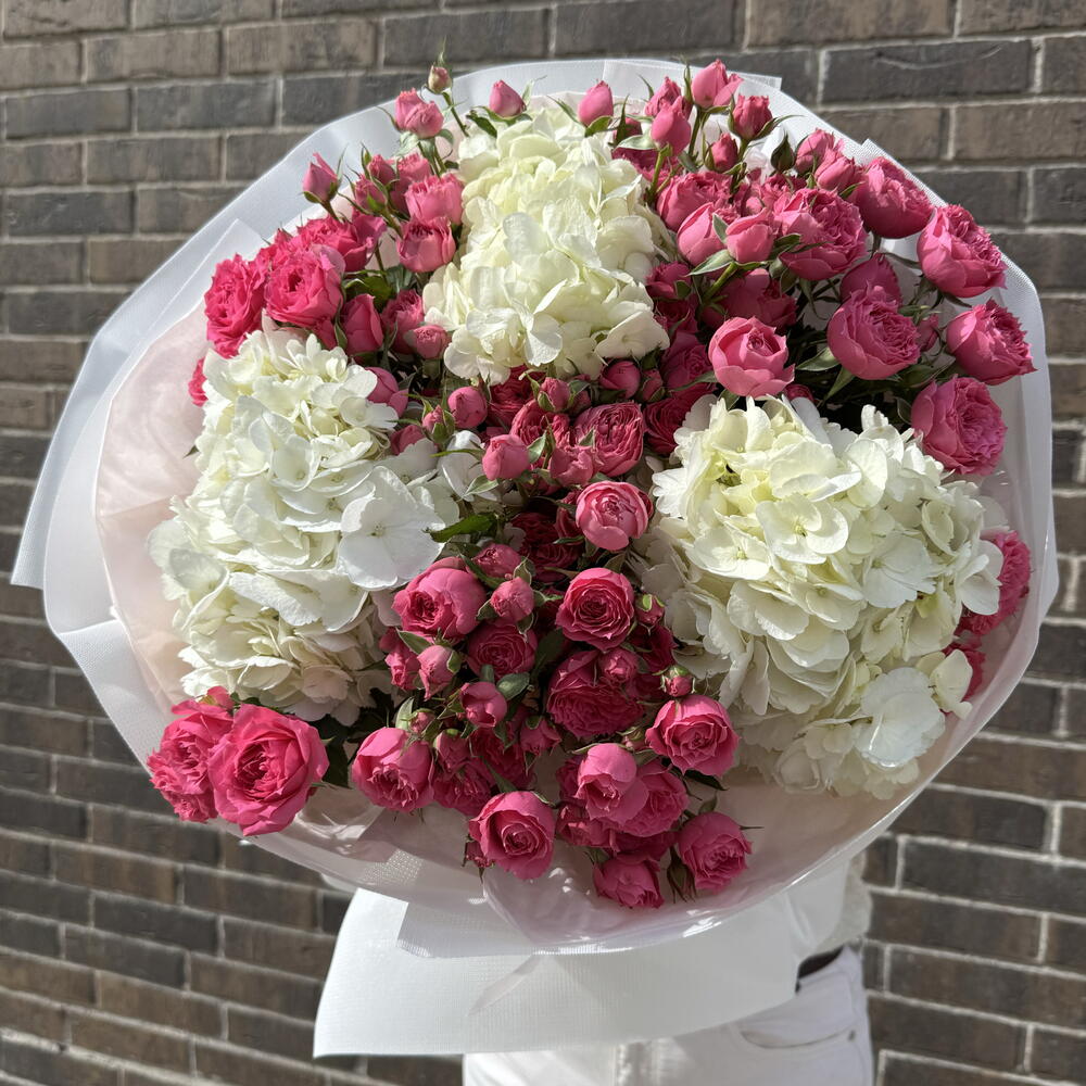 A huge bouquet of spray roses and hydrangea
