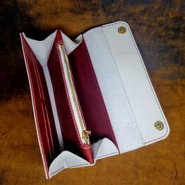 The wallet is made of genuine leather, handmade. The color is red and white