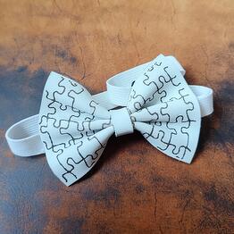 A butterfly made of genuine leather. Handmade work. Color: white. Pattern: a puzzle