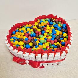 A heart of kinder chocolates with ememdems