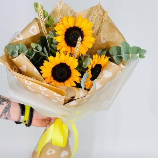Sunflowers with eucalyptus in a craft bouquet