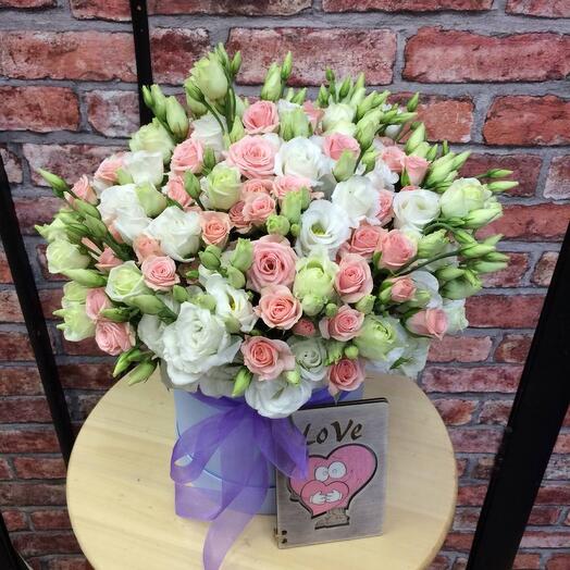 Delicate eustoma and bush rose in a box