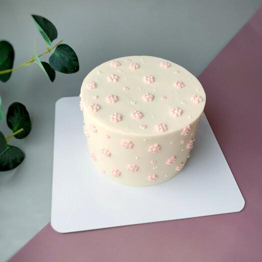 Vanilla strawberry cake with delicate decor flowers