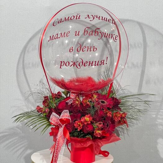 A red bouquet of flowers with a bubbles ball as a birthday present for mom and grandma