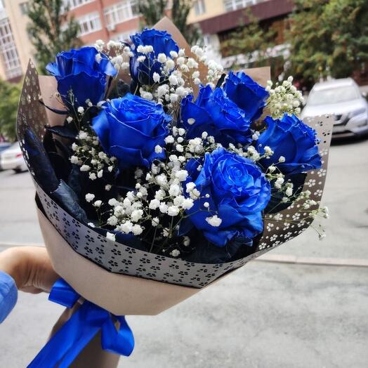 Blue roses and gypsophila in a craft bouquet