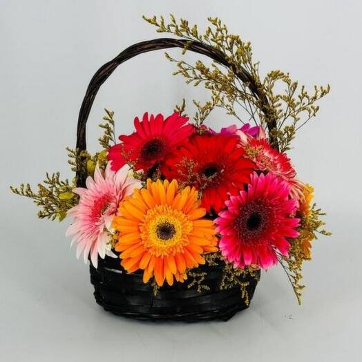 Colorful gerbera flowers in a basket