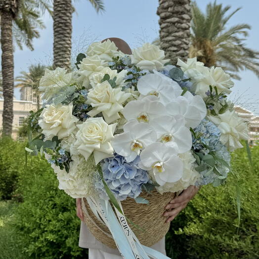 Basket with hydrangeas, phaleanopsis and roses