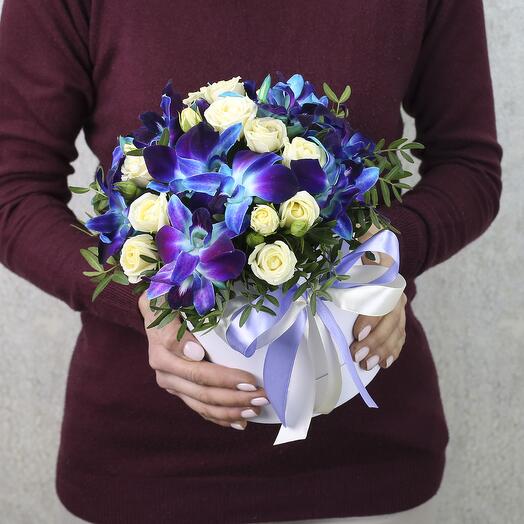 Bushy white roses and blue orchids in an Amethyst box