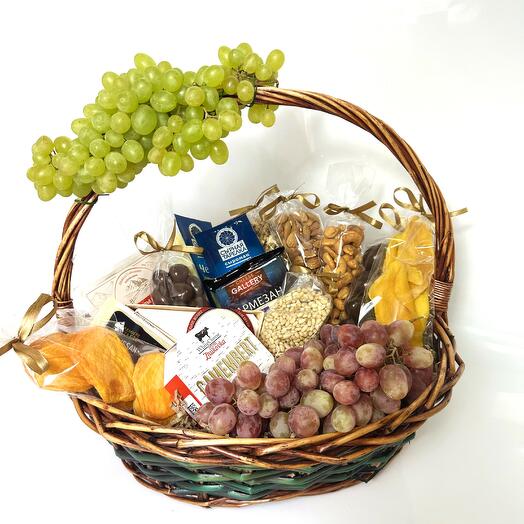 Bouquet in a basket of cheese, nuts and dried fruits