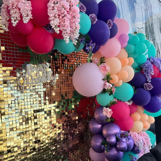 Balloons garland with shiny wall and flowers decorate
