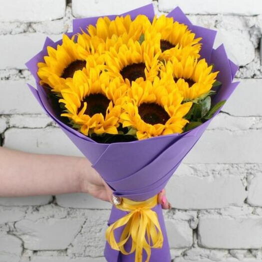 Bouquet of 7 sunflowers with greenery in a purple package