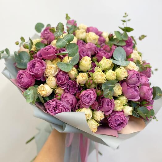 A large bouquet of peony-shaped roses with eucalyptus