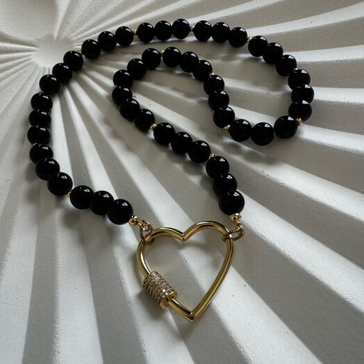 Black agate necklace features a heart-shaped clasp coated in 18-carat gold