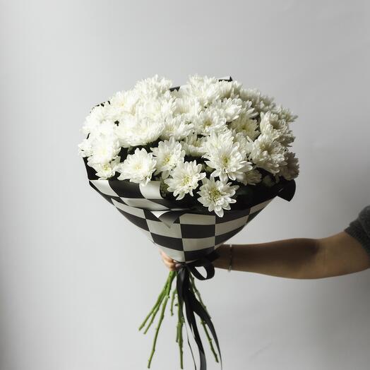 A magnificent bouquet of snow-white chrysanthemums in a stylish package