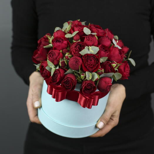 Red peony-shaped bush roses with eucalyptus in a blue box