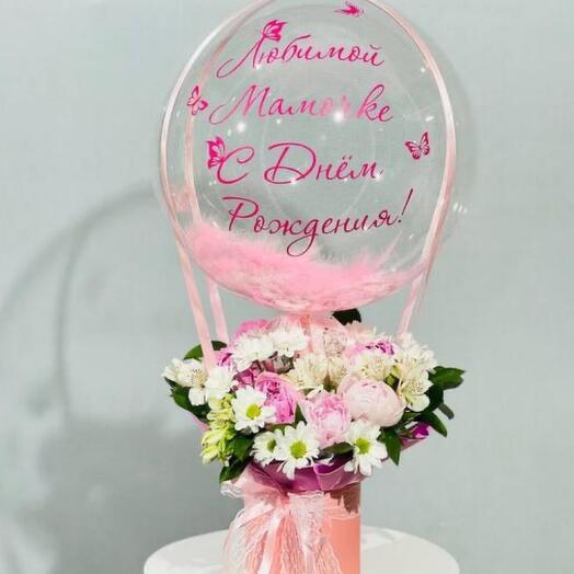 A birthday present for mom, a bouquet of flowers with peonies and a bubble ball