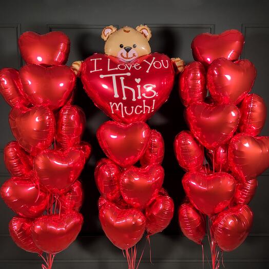 Large composition of red hearts with a bear