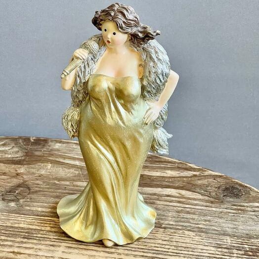 A lady singer in a gold dress with a microphone