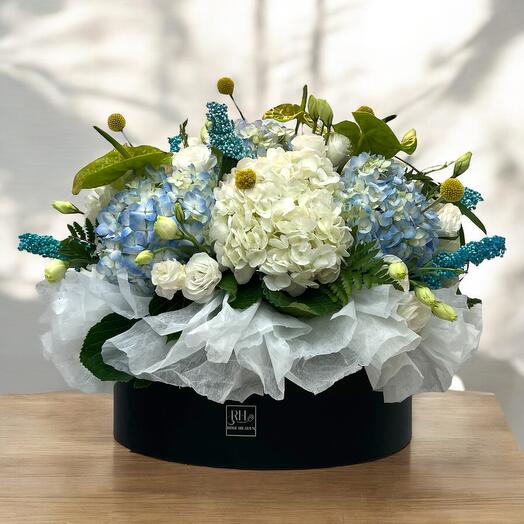 White and blue round bouquet in leather box