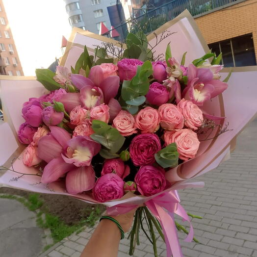 Bouquet of flowers orchid, limonium, alstroemeria in designer packaging