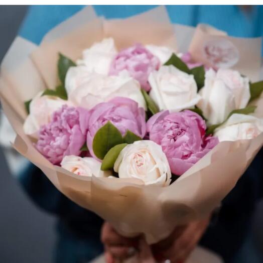 Peonies and white roses in stylish parchment