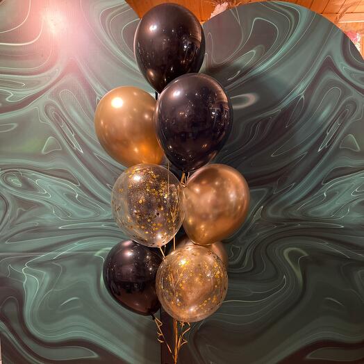 Stylish fountain of helium balloons in black and gold with cool confetti