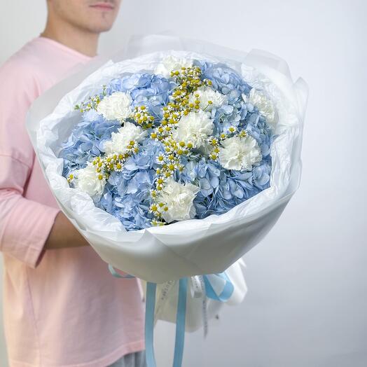 Delicate white bouquet of blue hydrangeas, daisies and carnations