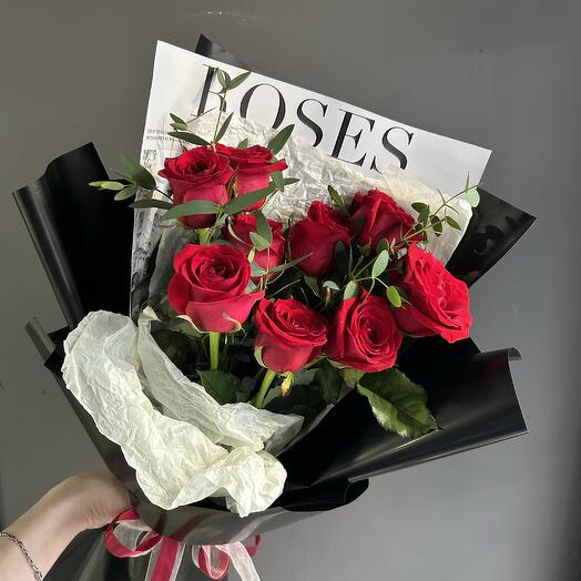 Bouquet of red roses and eucalyptus twigs in black design
